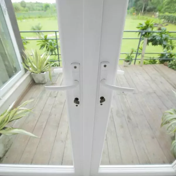 A wooden deck with a white door.